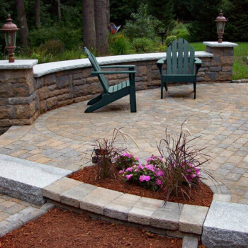 Stone paver sitting area surrounded by beautiful block stone all