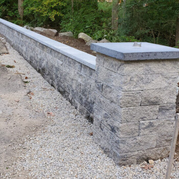 Block stone wall with raised front stone pillar
