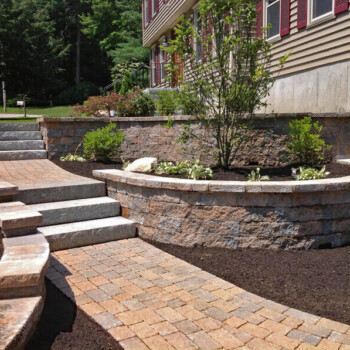Curved stone block walls on two tiers with stone steps