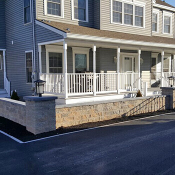 Stone block wall in front of house