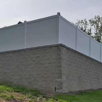 Stone block wall with privacy fence on top