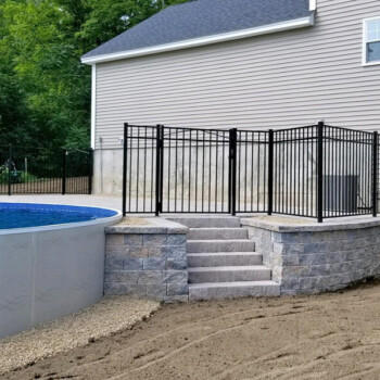 Above ground pool with raised stone patio